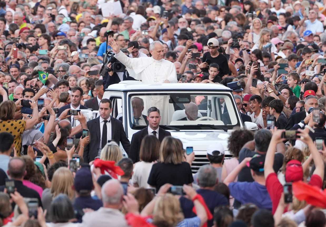 Pope Leo XIV rides in the popemobile before a prayer vigil